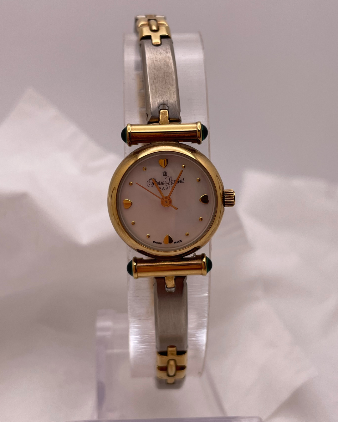 Two-tone watch with gold and silver band on a white background